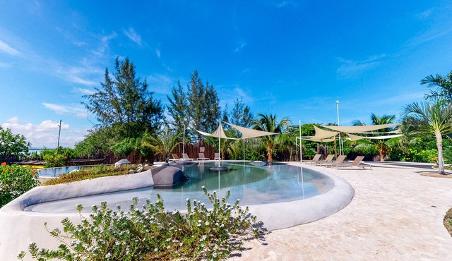 Beachfront retreat with pool, private hot tub, AC, & lagoon view in Placencia