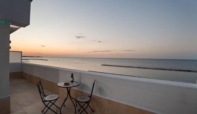 GuestHost - Modern apartment of about 50sqm, with a wonderful terrace of 70 sqm with a view on sea and lighthouse, able to accommodate 4 people with every comfort. The property is located in an enviable position, facing the beach and only 6 km from the a